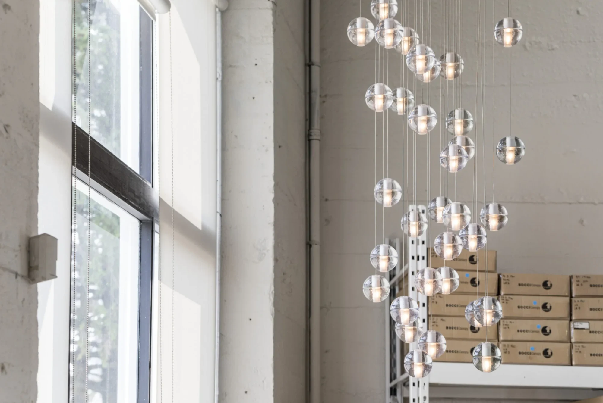 Bocci 14 series glass pendants hanging in a Bocci building with a window wall
