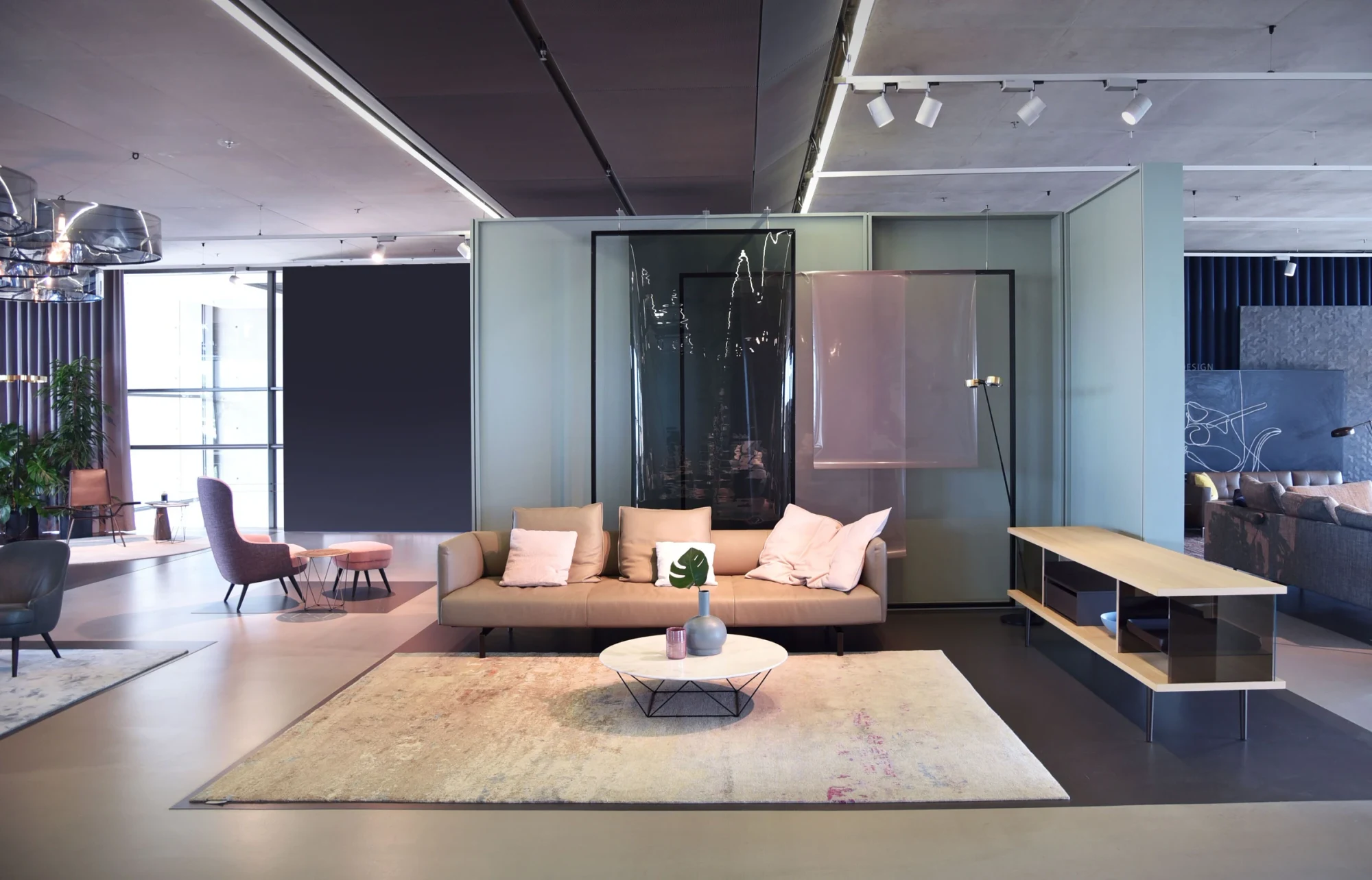 A sofa with a low table on a rug inside the Herrenberg showroom