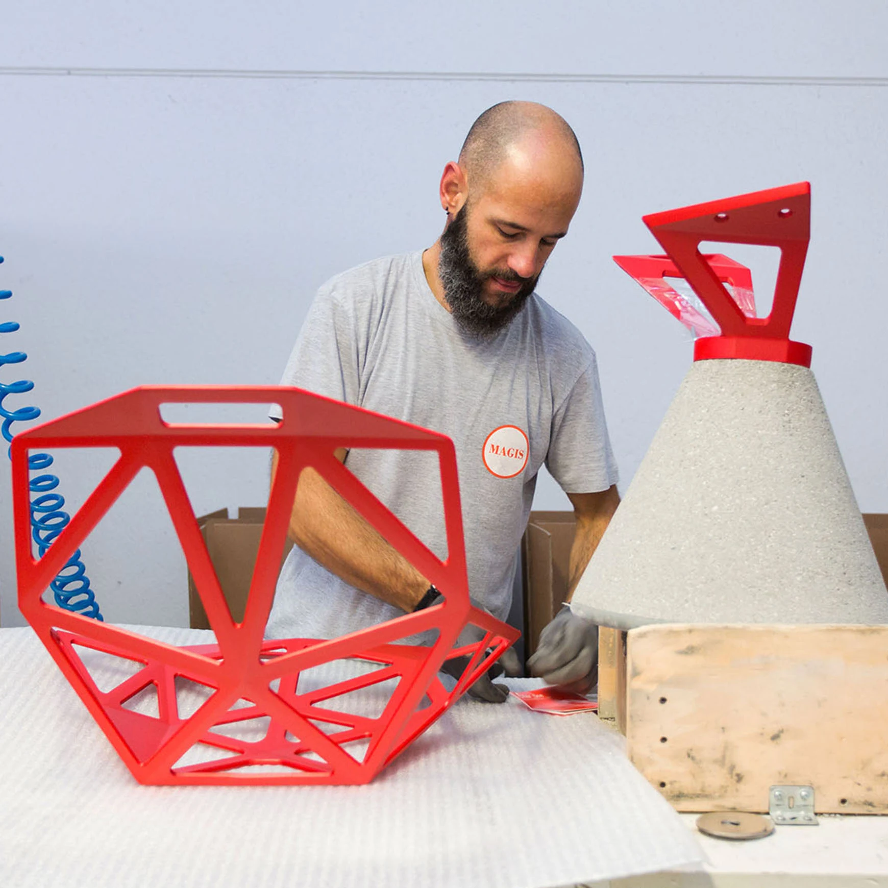 Assembling a red Chair One at the Magis factory
