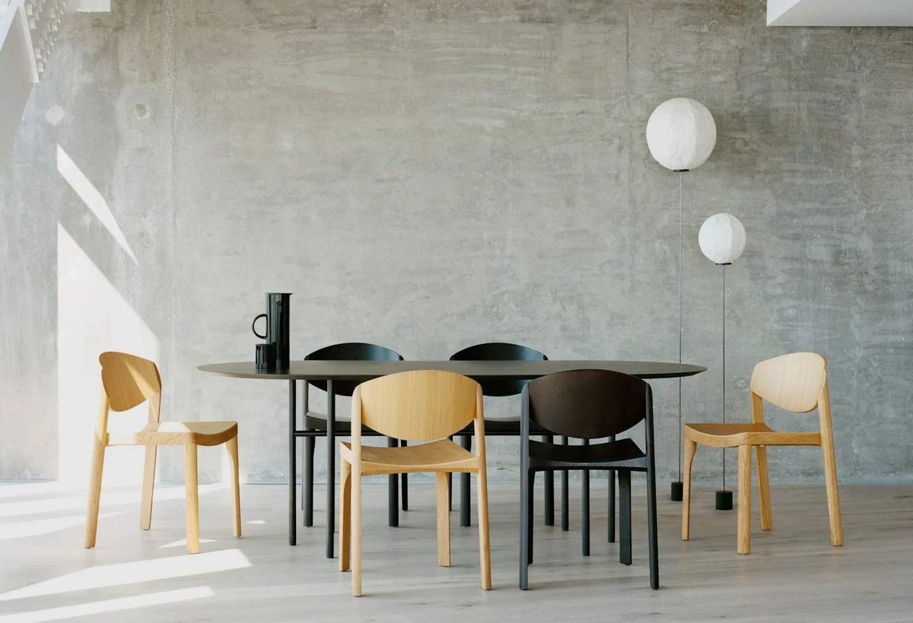 Mauro chairs around a dining table in a concrete-walled room