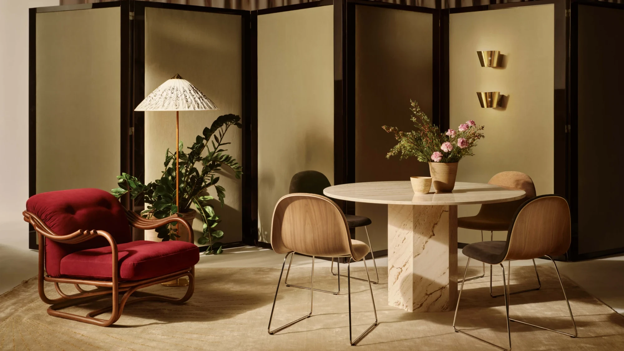 GUBI dining table with chairs in a warm interior