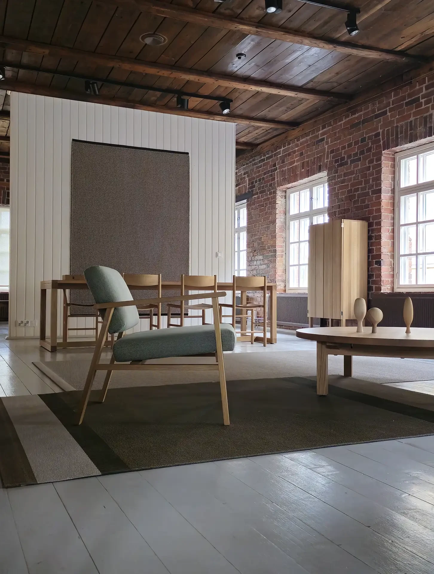 Nikari studio showroom with solid wood furniture in a brick hall
