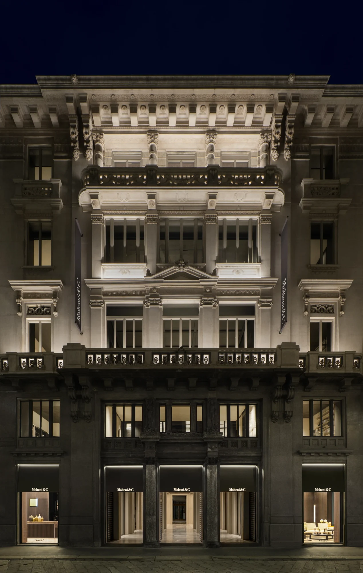 Palazzo Molteni flagship building facade at night