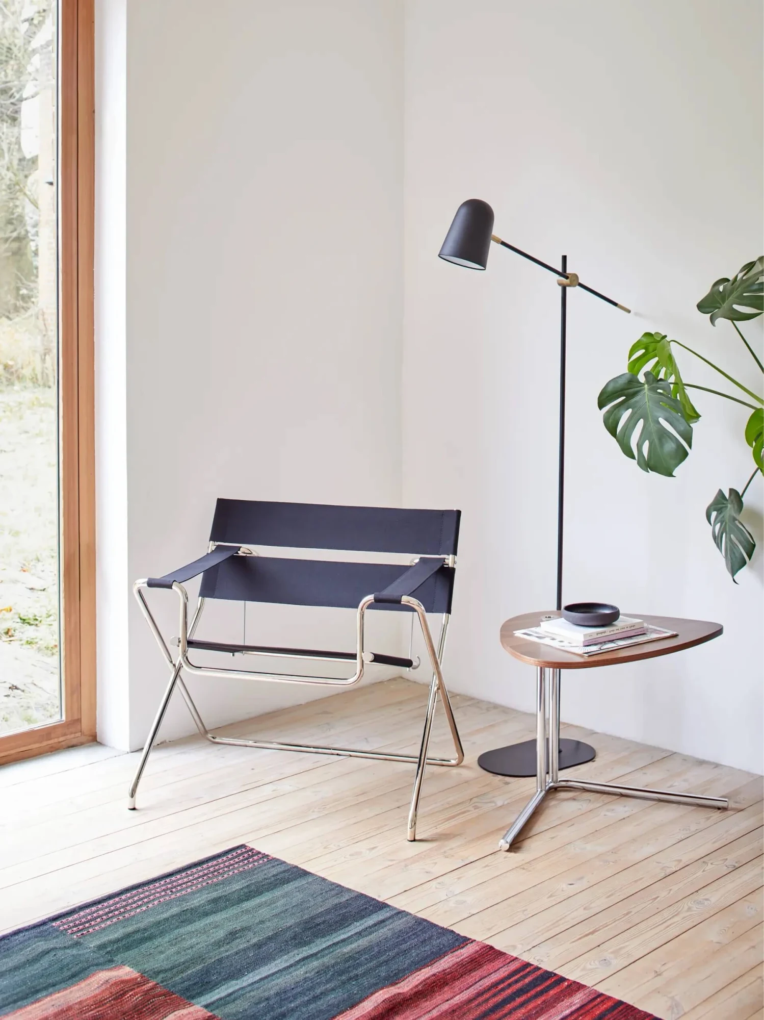 Tecta chair with a side table and floor lamp in a bright room