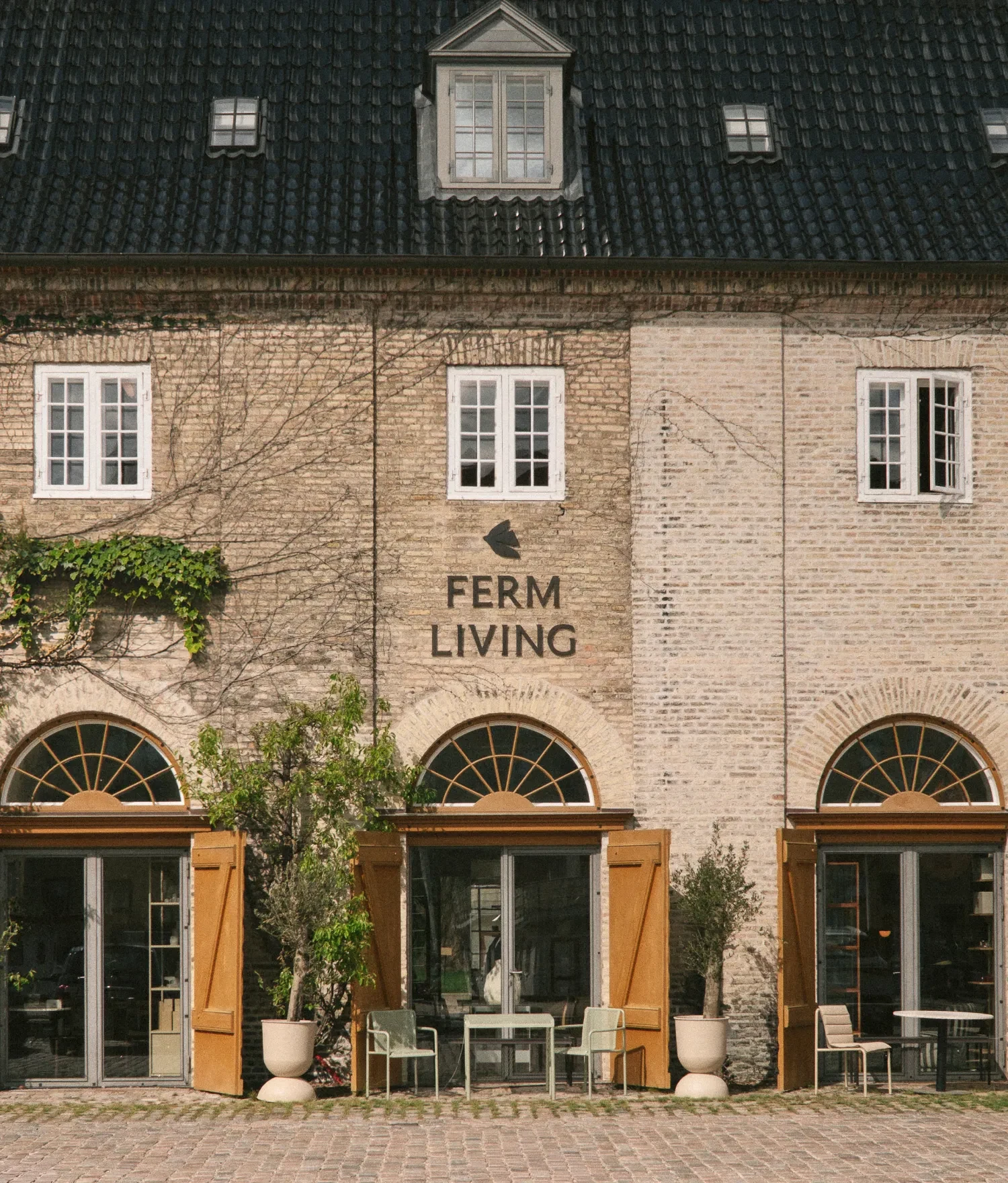 The Home of ferm LIVING, a brick building with arched windows in Copenhagen
