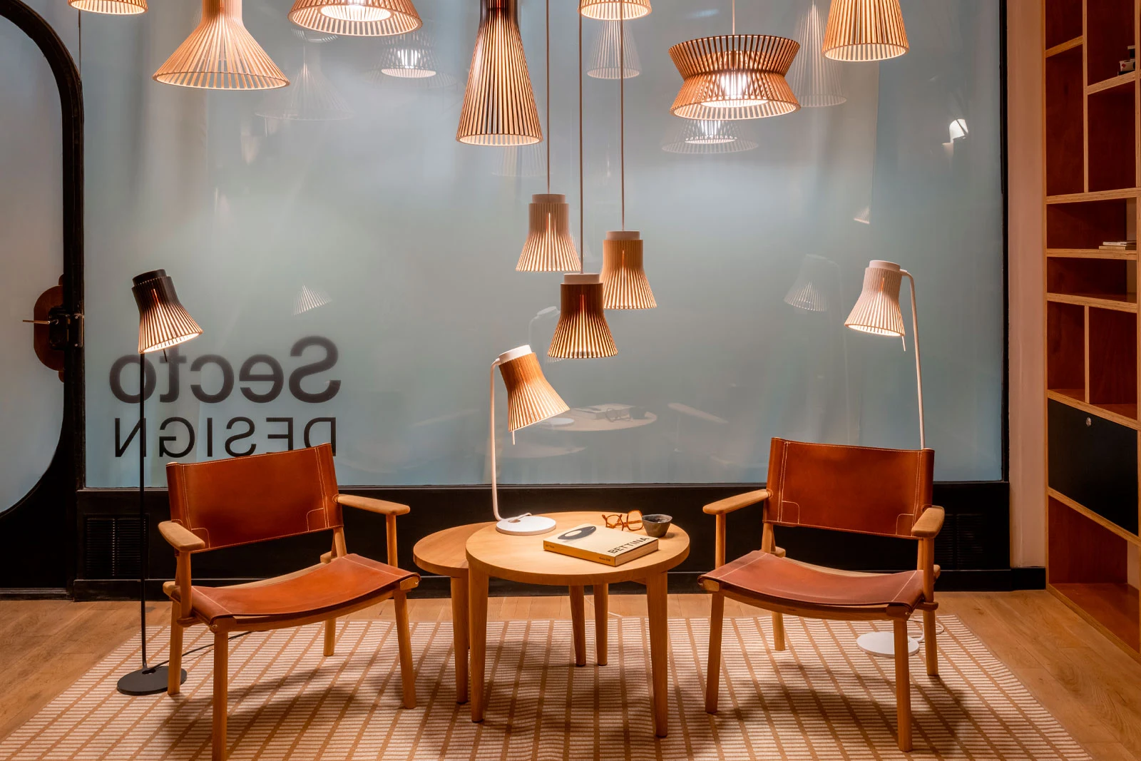 Secto Design lamps and armchairs in an office lounge