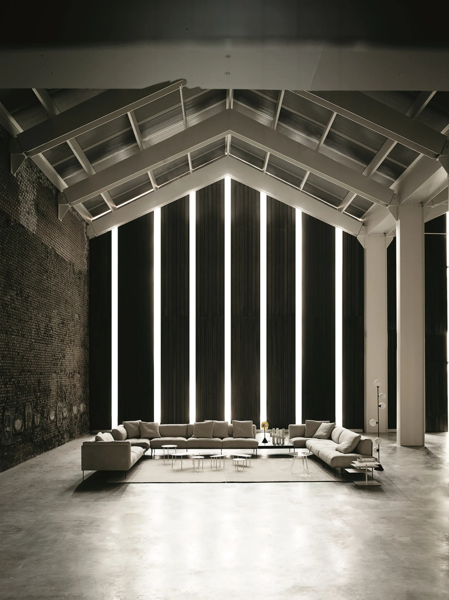 Living Divani sofa group in a large hall with a pitched roof
