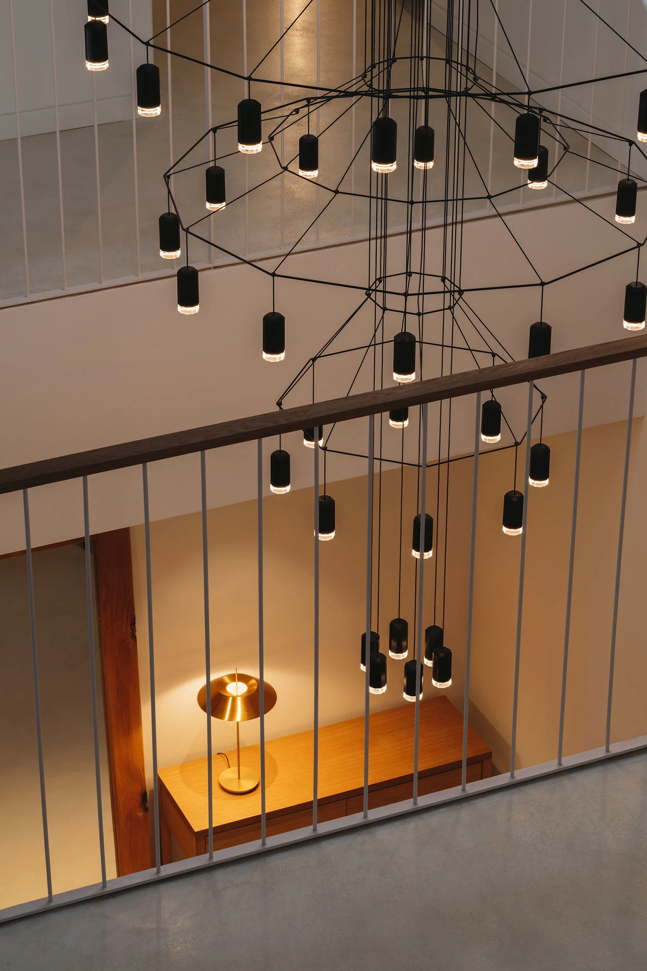 Vibia suspended lamp with black cylindrical lights above a stairwell