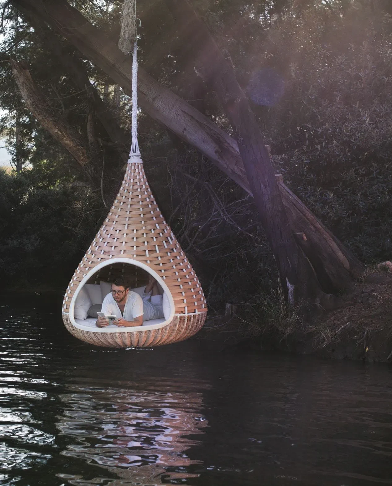 NestRest hanging lounger suspended over water