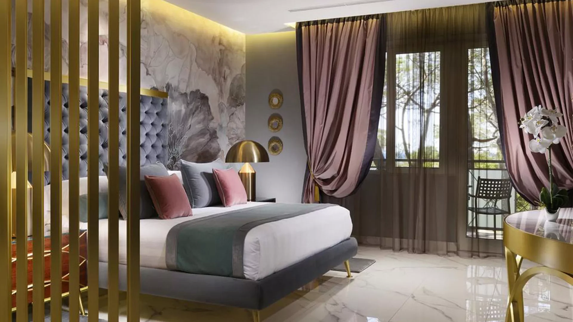 Atollo table lamp beside a bed in the Exotik Suite at Riva del Sole