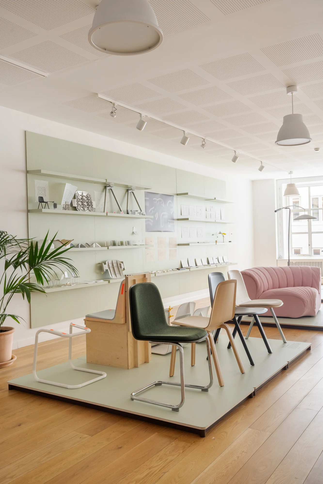 Muuto showroom with chairs on a display platform and shelving