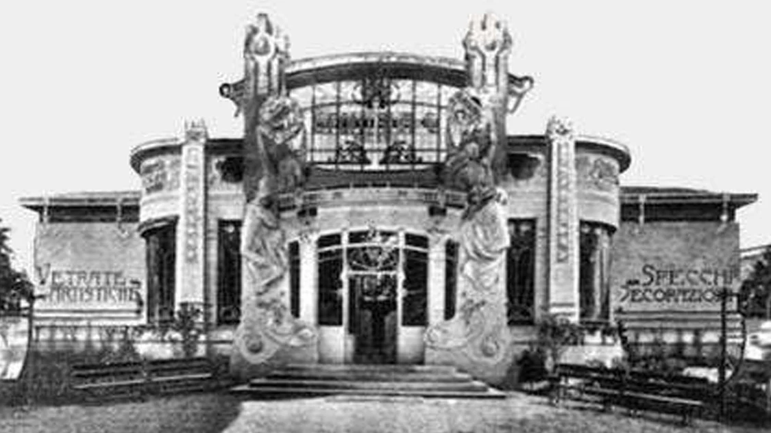 Historic black-and-white photograph of an ornate pavilion with signs for artistic glass and mirrors