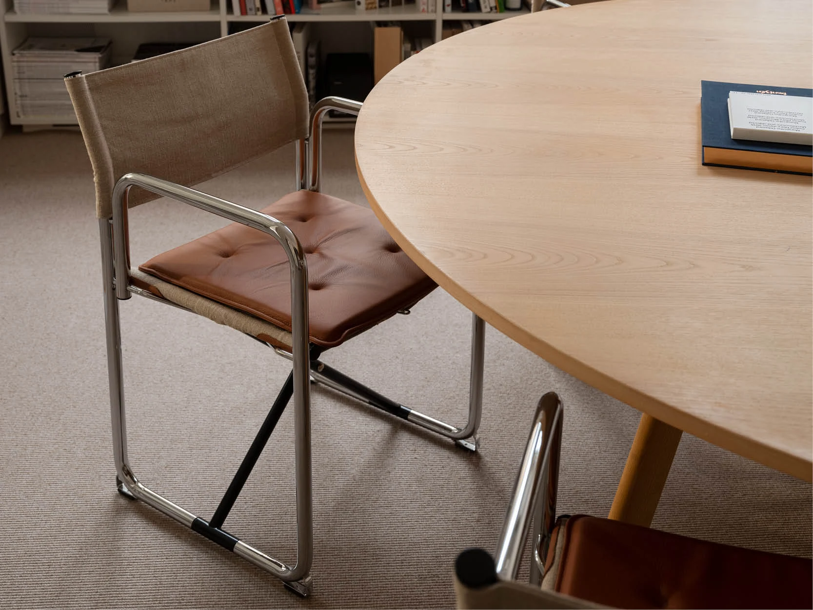 Lammhults tubular steel chair beside a round table