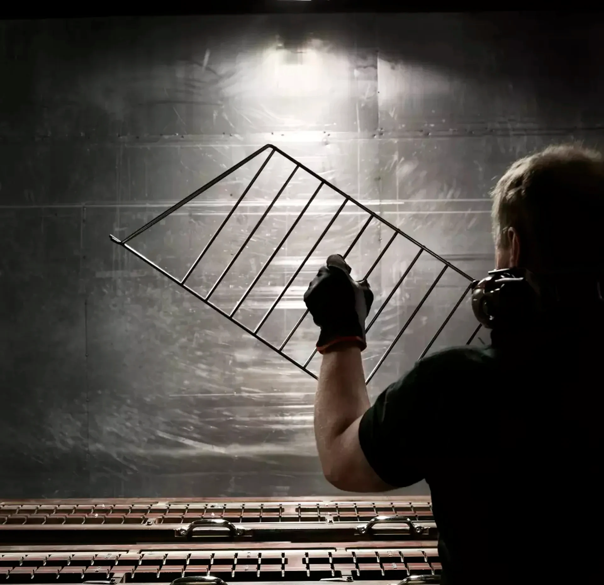 Person holding a metal String shelf side panel