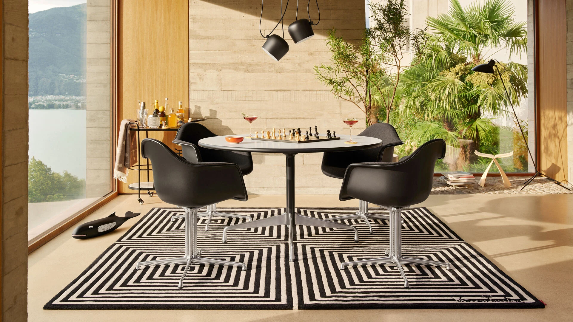 Four chairs around a round table in a room