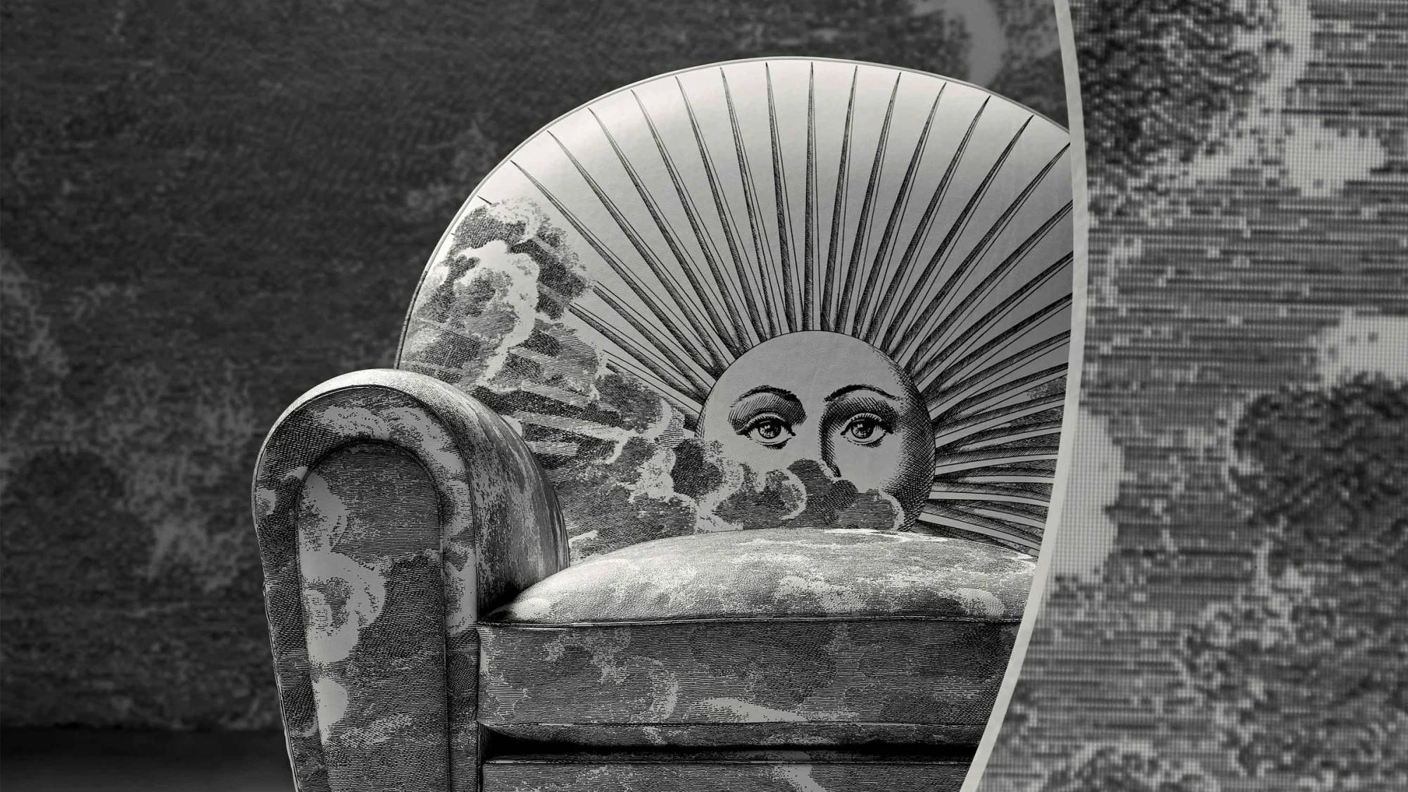 Close view of the Vanity Fair XC Imagine Edition armchair with a sun motif on its back and a cloud pattern