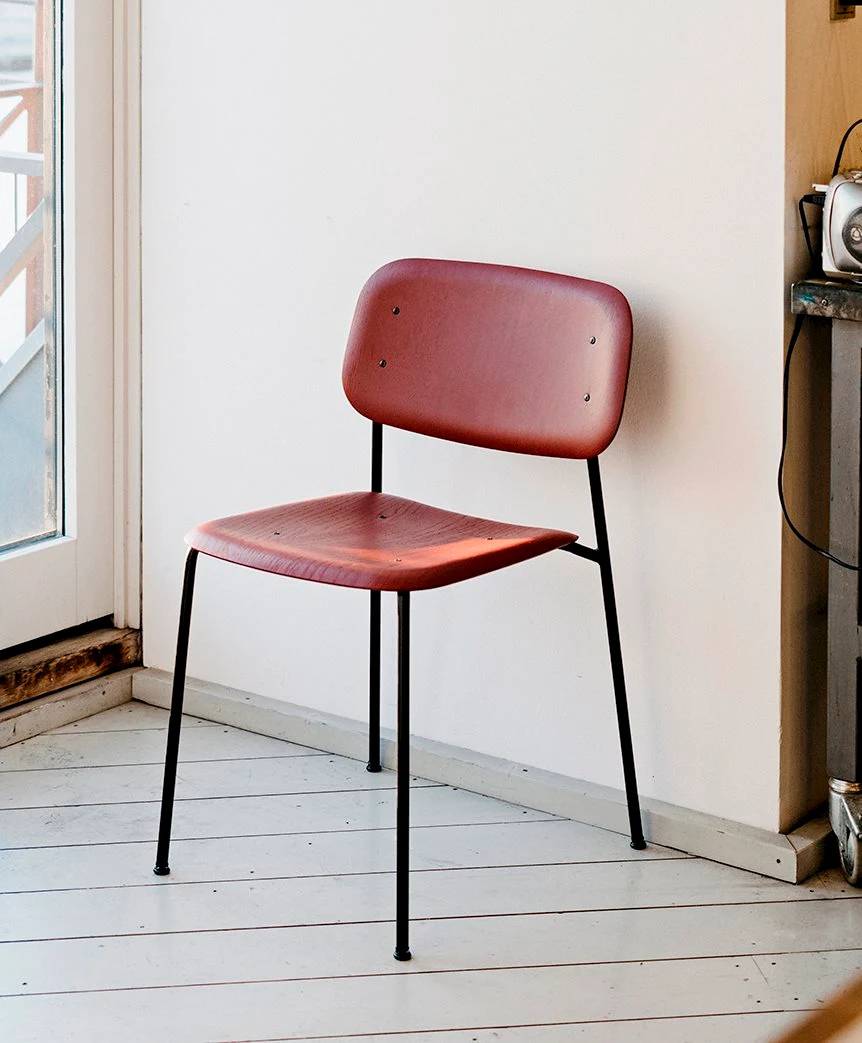 Chair with a steel frame in a room corner next to a window