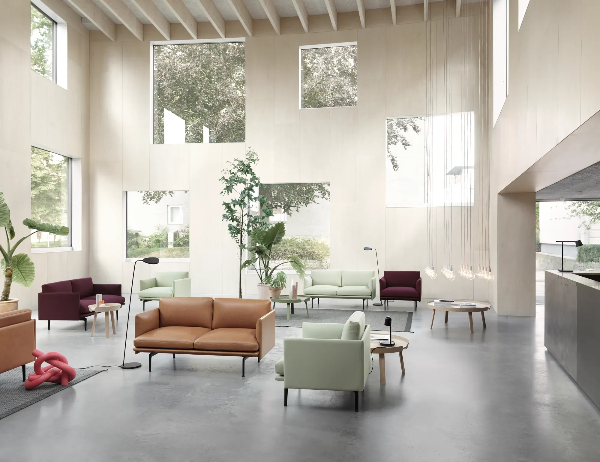 Outline Studio sofas and chairs grouped in a tall hall with high windows