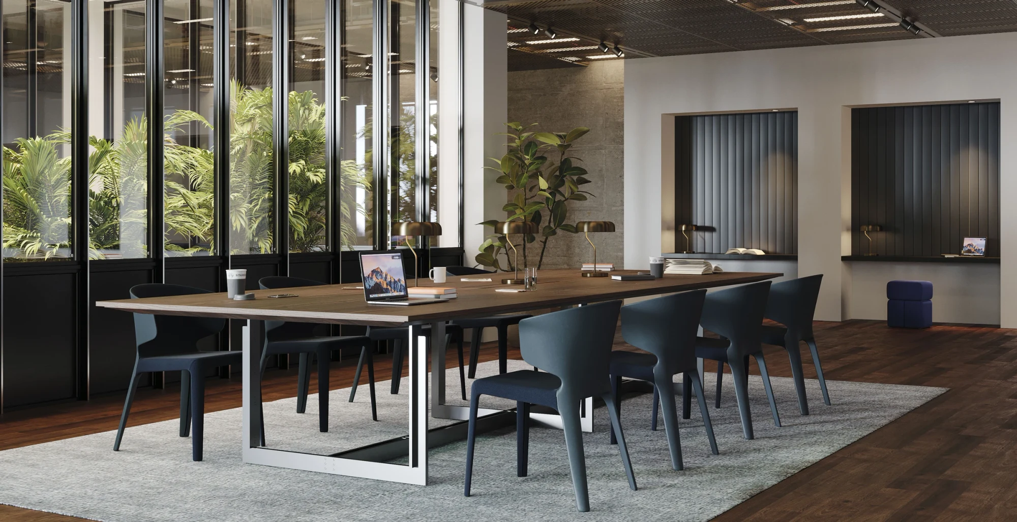 A long table with chairs in a room with large windows