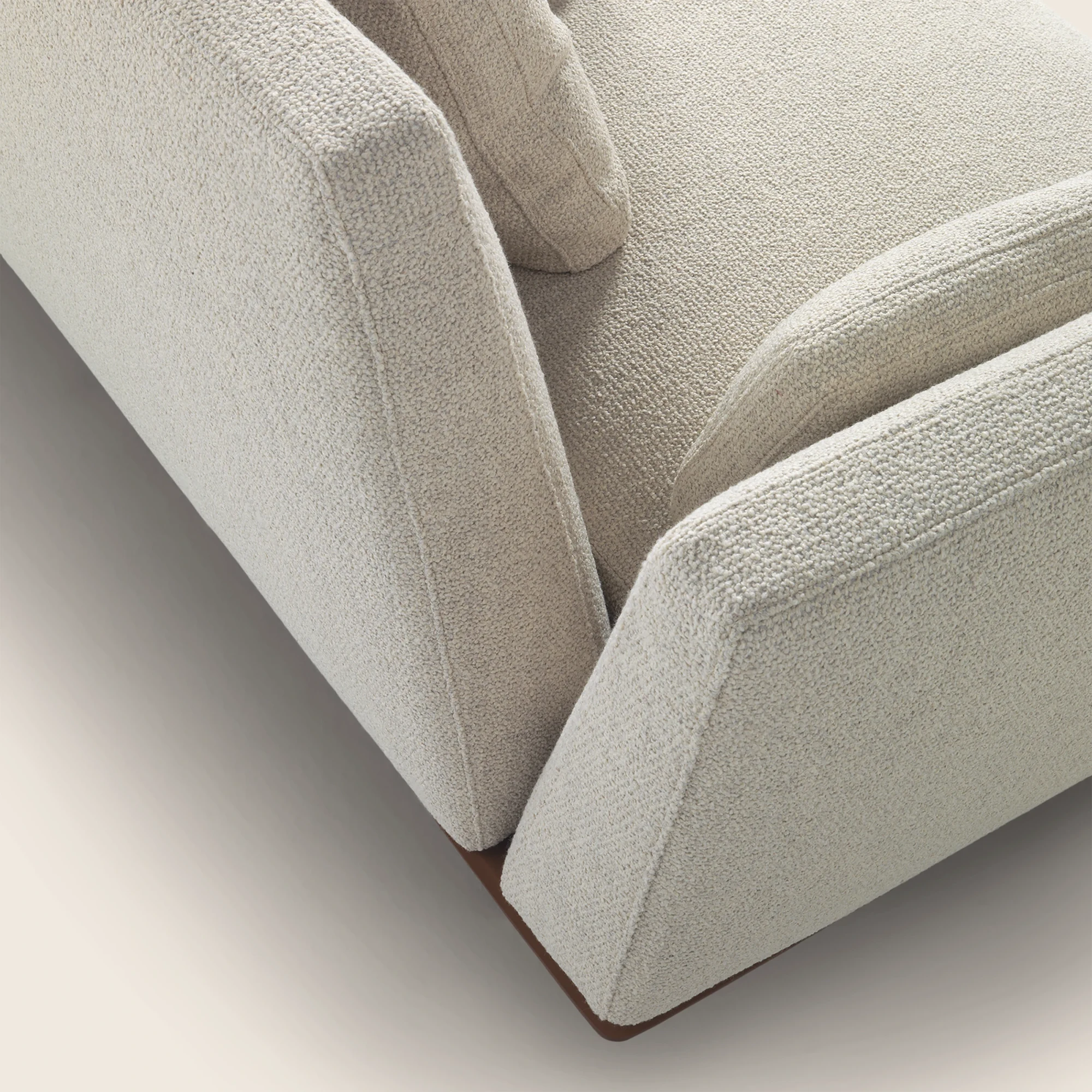 Close view of an upholstered armrest and seat corner of the Evergreen sofa