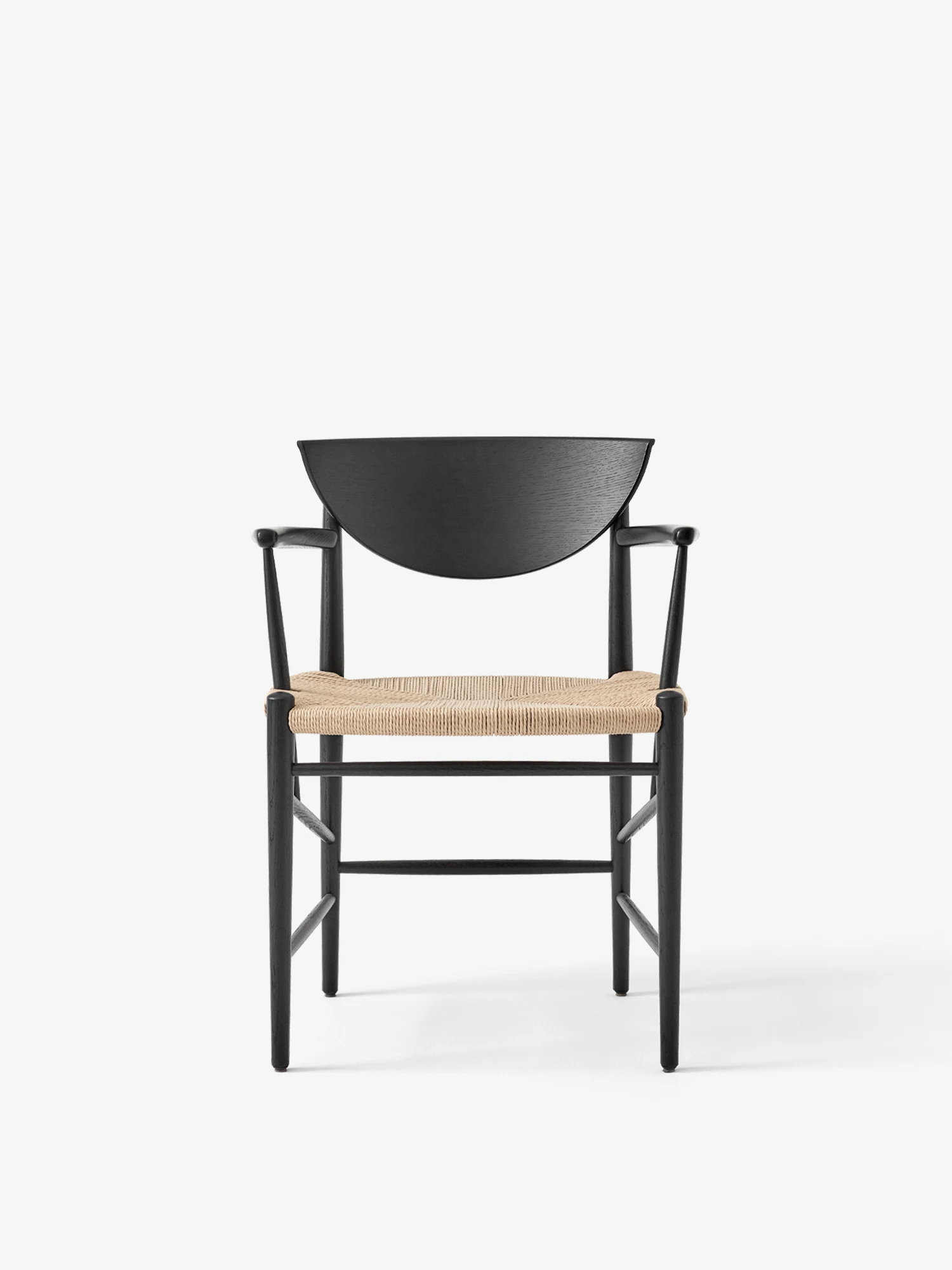 Drawn armchair with a woven seat seen from the front