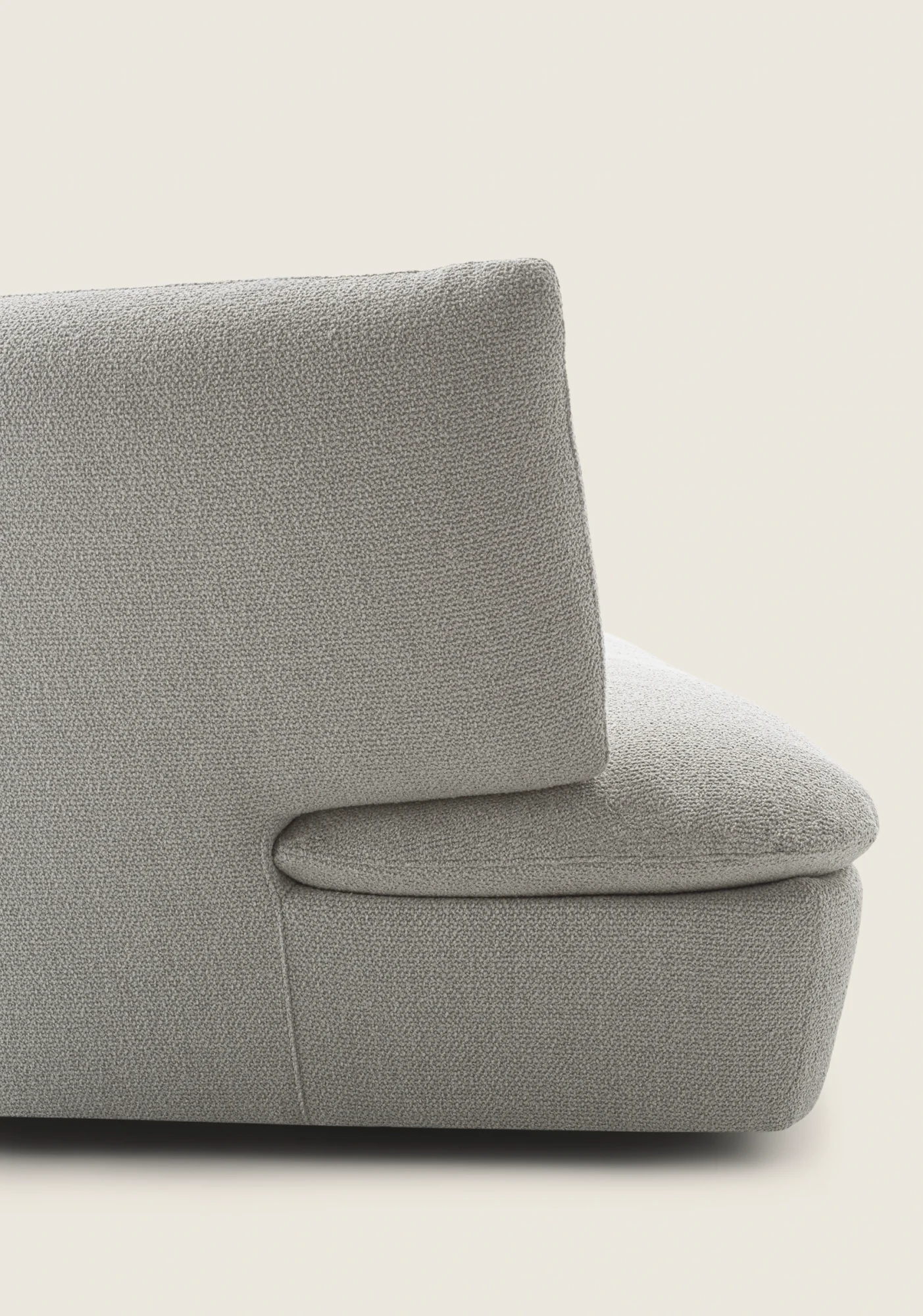 Close view of a rounded armrest and backrest of a Quincy sofa