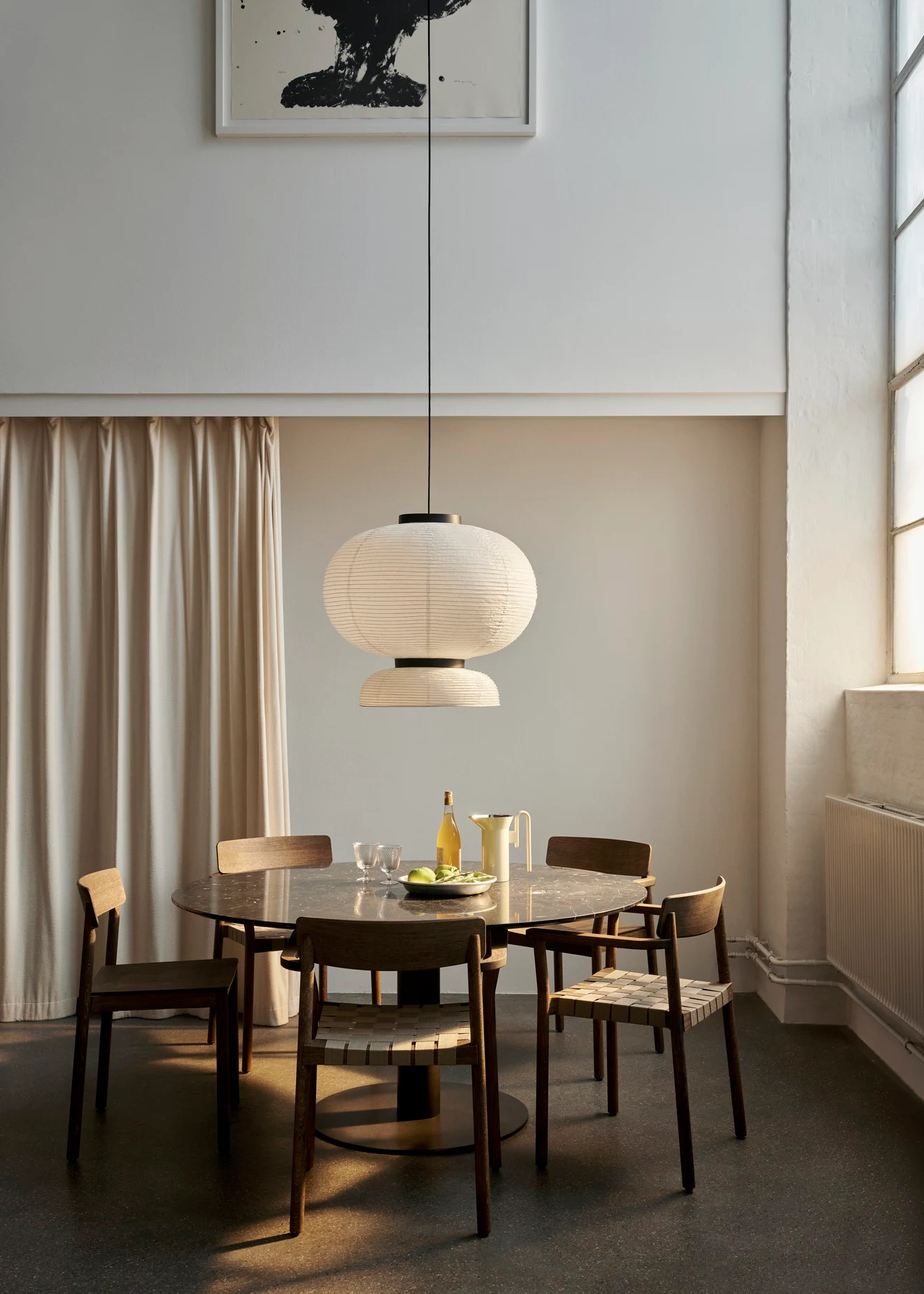 Betty chairs and armchairs around a round table in a room