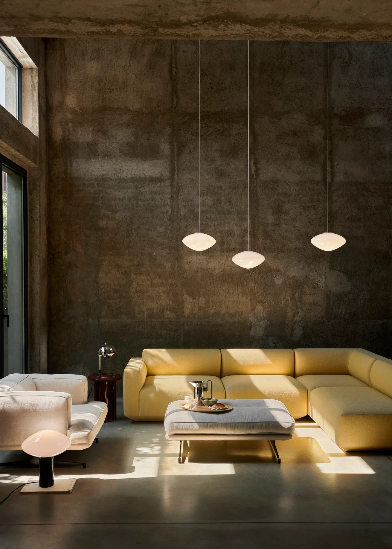 Develius sofa modules in a room with pendant lamps