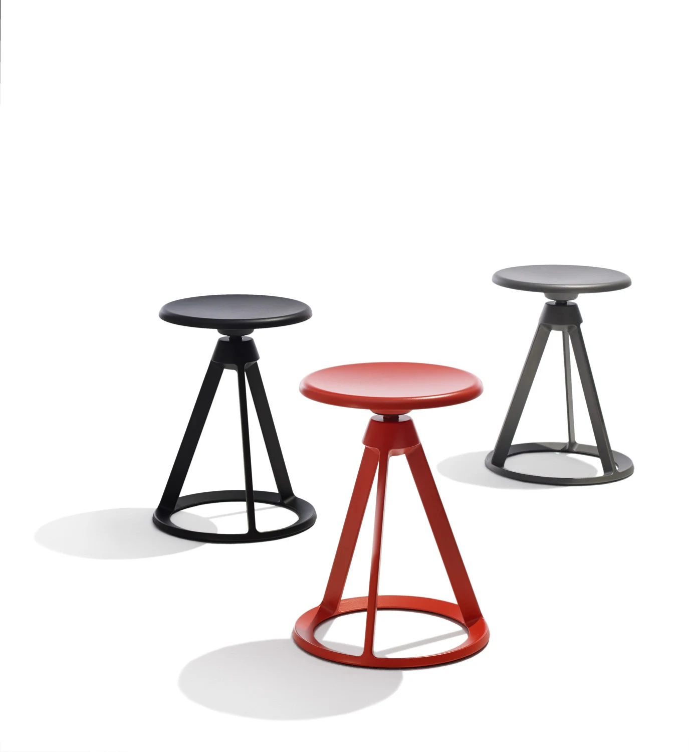 Piton stools in a loose group on a plain white background