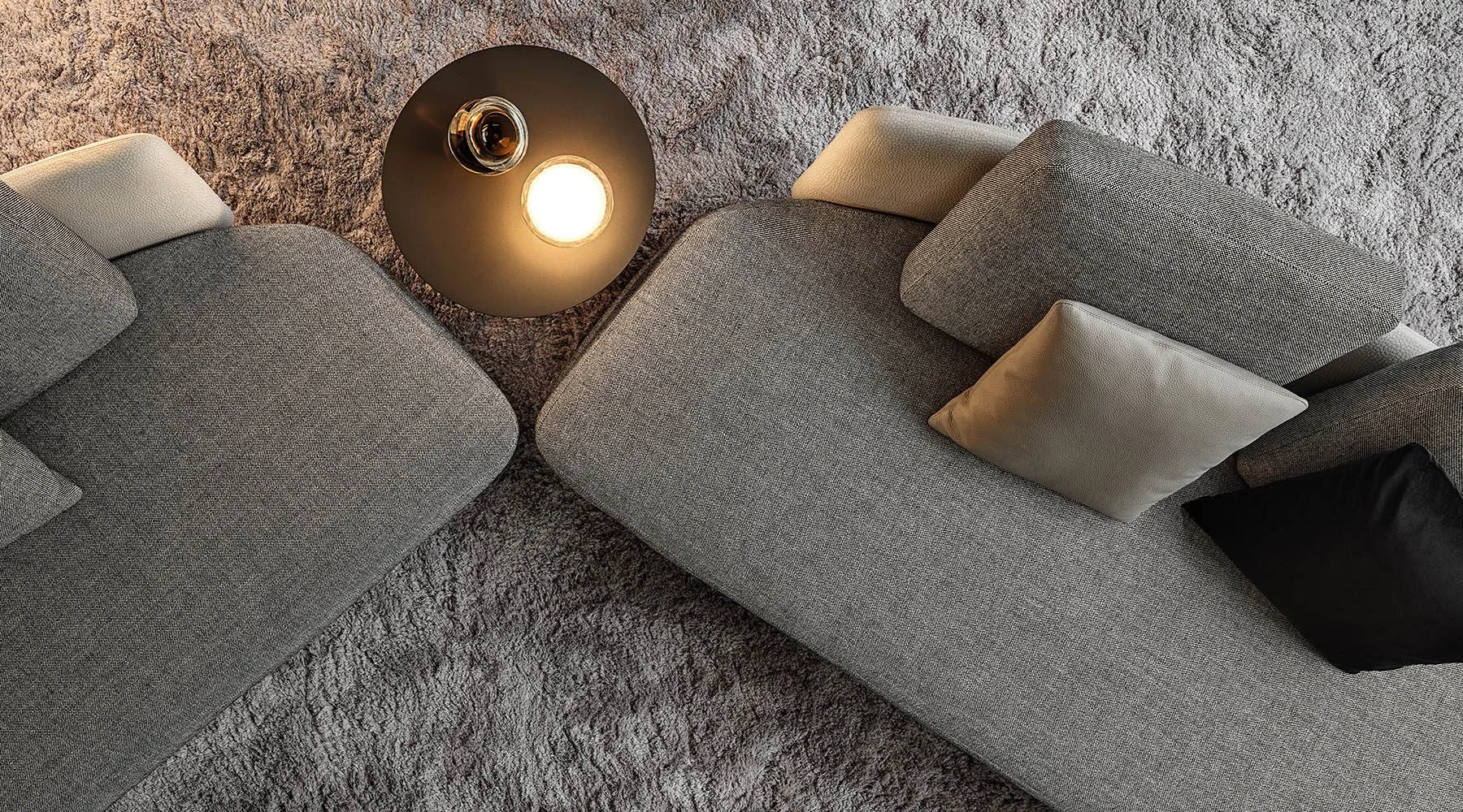 Top view of two Lawson elements with cushions and a lamp on a rug, official Minotti photo