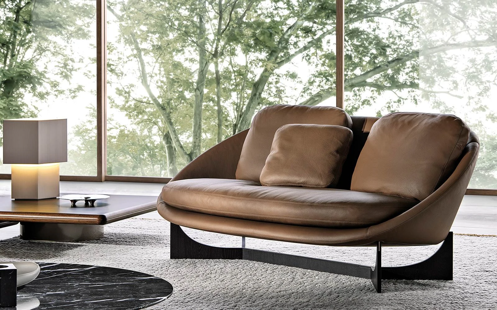 Brown leather Lido sofa on a dark base, official Minotti photo