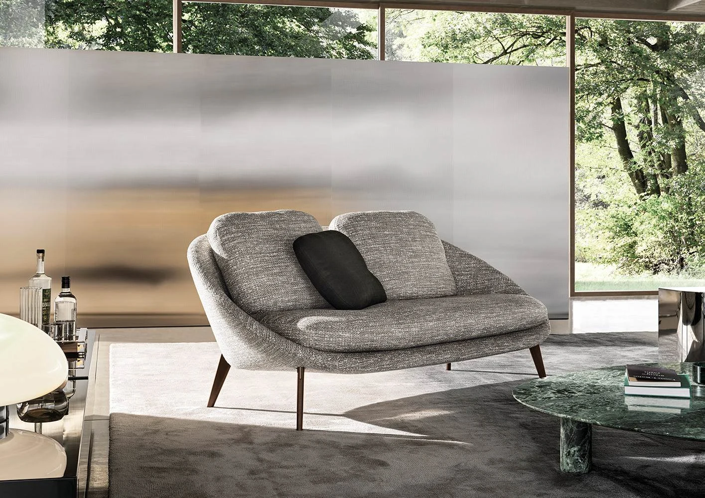 Lido sofa with a dark cushion in a room with a large window, official Minotti photo