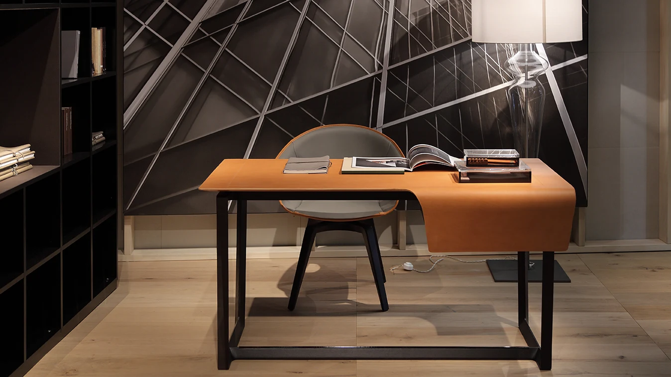 Desk with a chair at it in a room with a rug and wood panelling