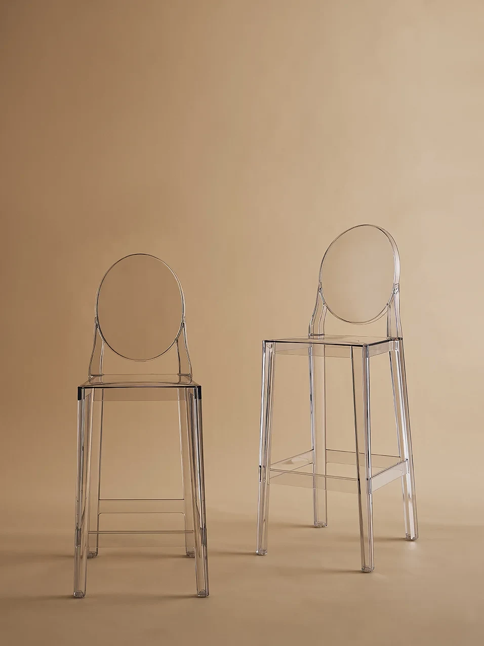 Two stools in front of a plain wall