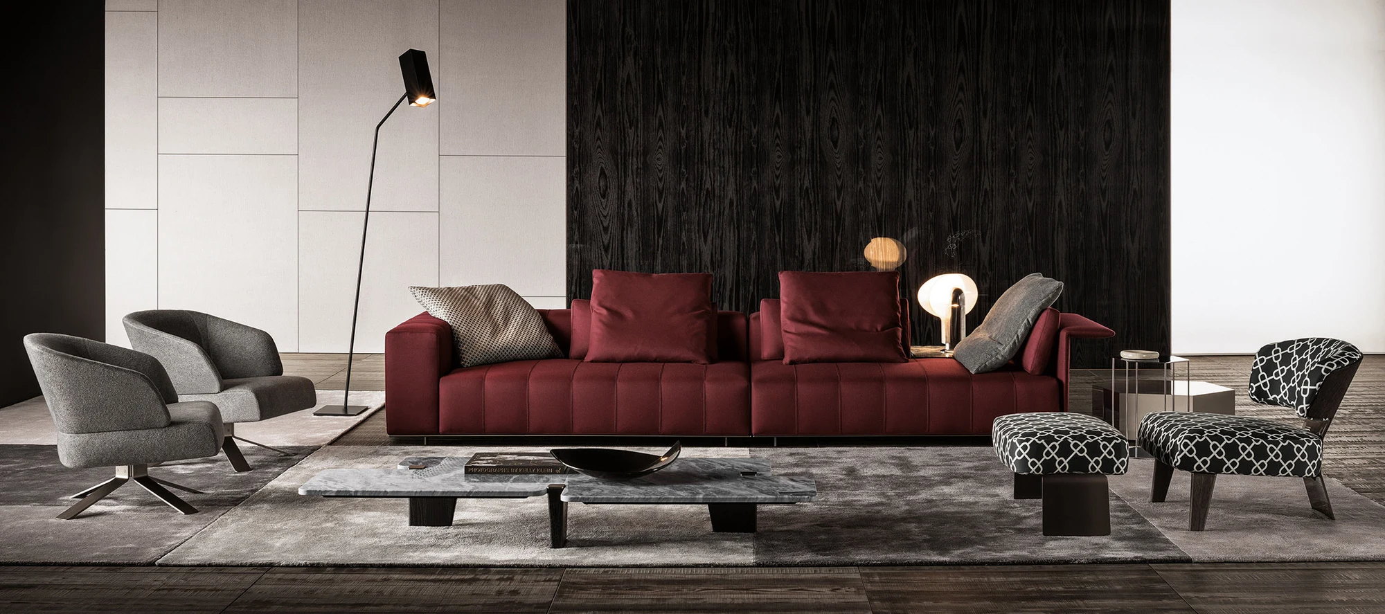Long sofa with two armchairs, a floor lamp and a low table in a room, official Minotti photo