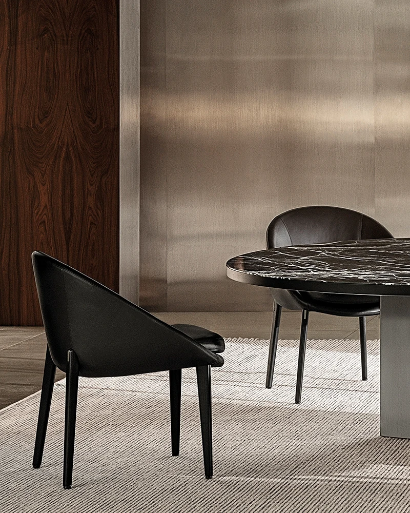 Dining little armchair with a curved shell, seen at an angle