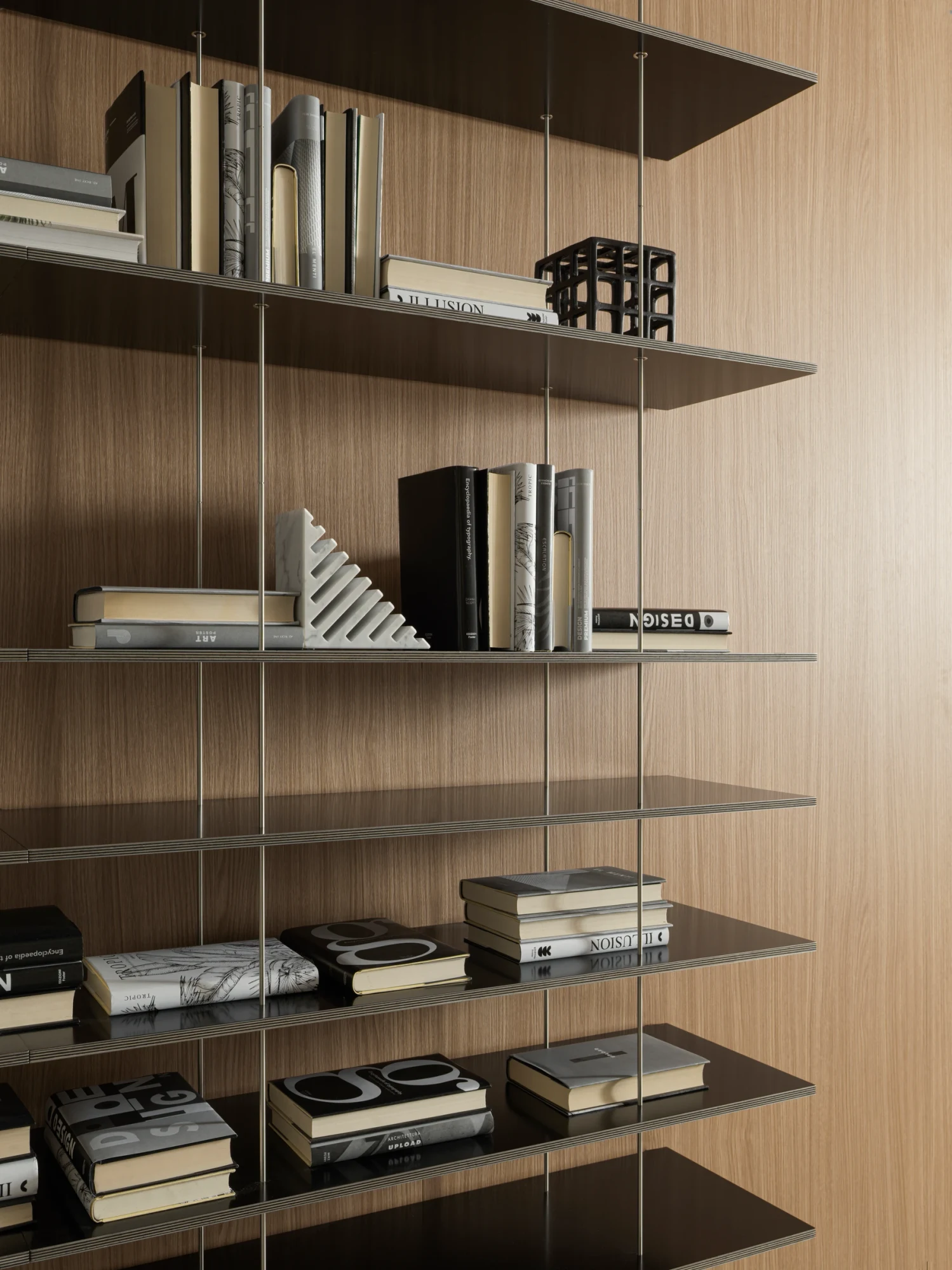 Close view of shelves hung from thin rods in front of a wall panel