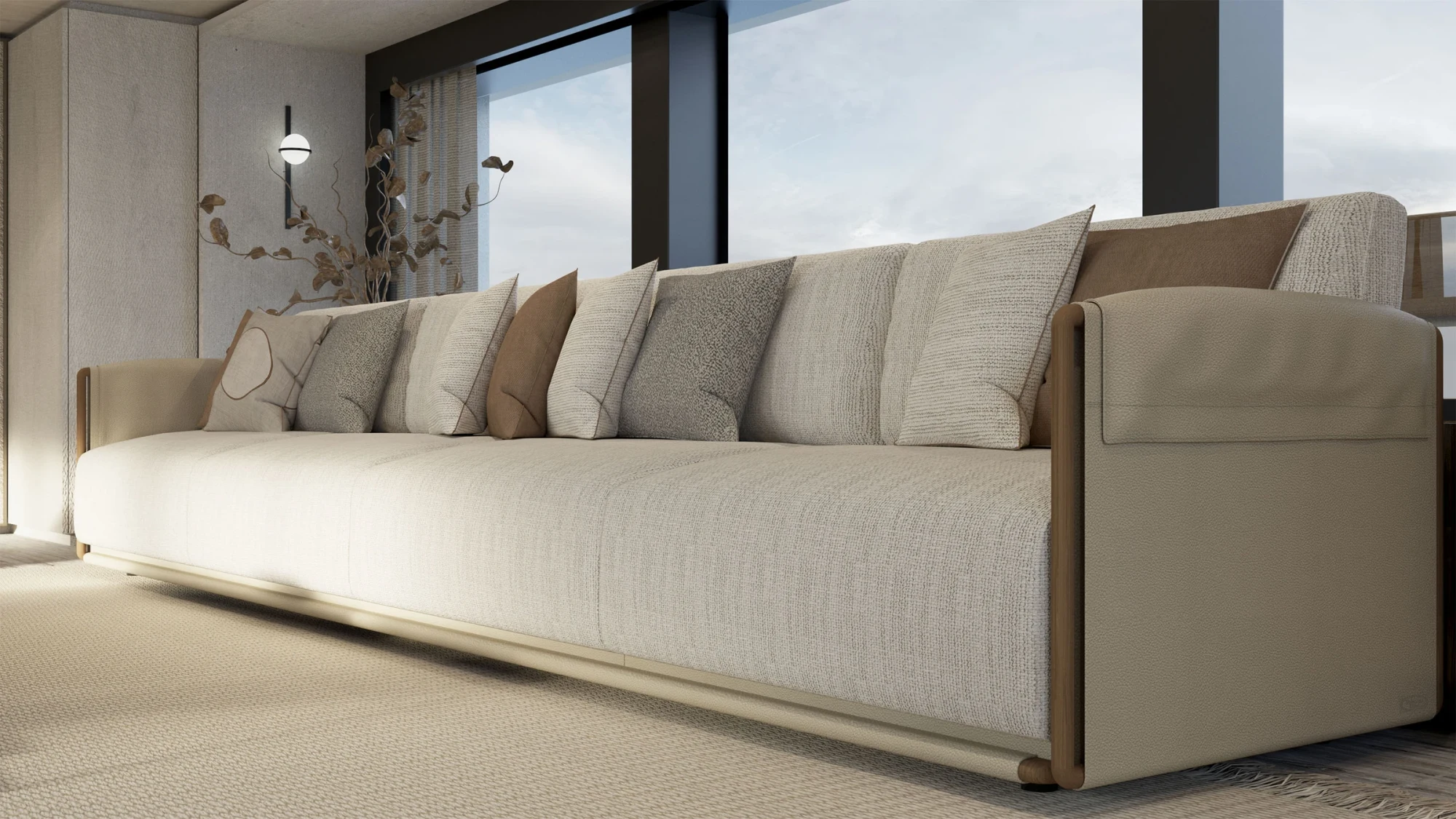 Close view of a long sofa in a room with large windows