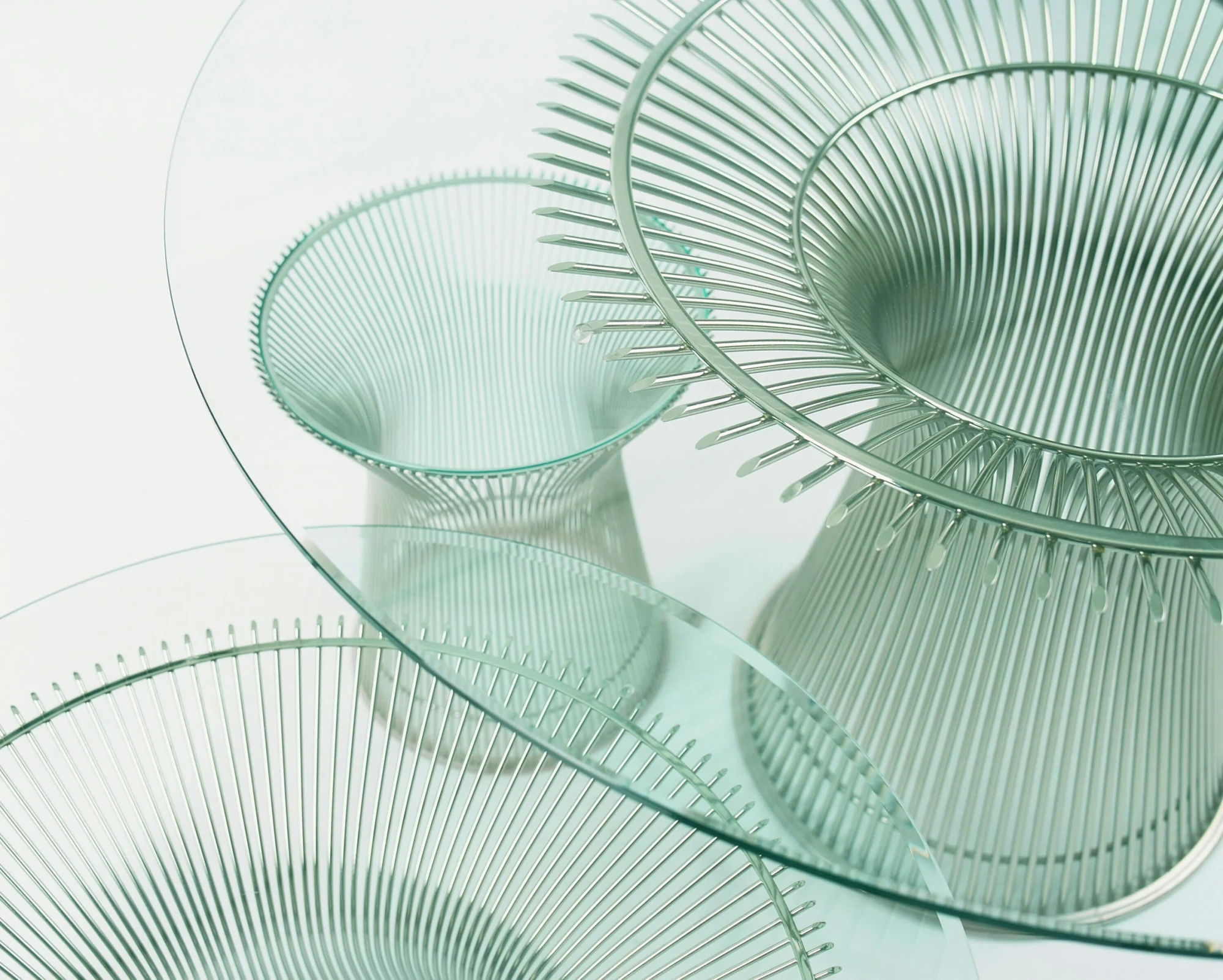 Close view of glass table tops and rod pedestals (official Knoll photograph, caption 4470 Platner Tables)