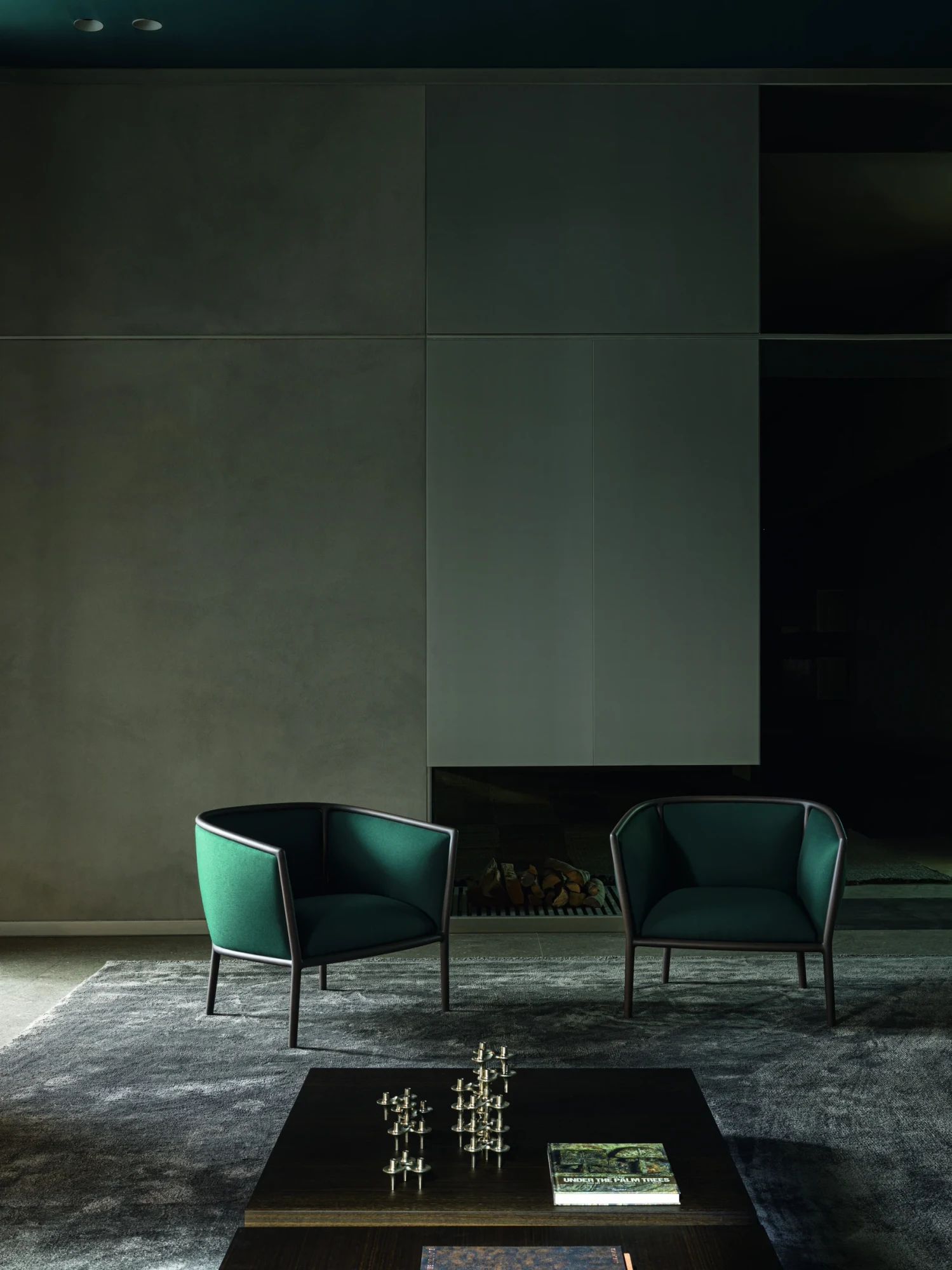 Two Margou armchairs beside a low table with objects on it