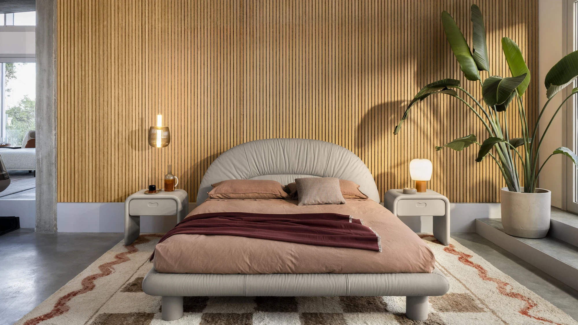 The bed seen from the front in a room with a bedside unit on each side