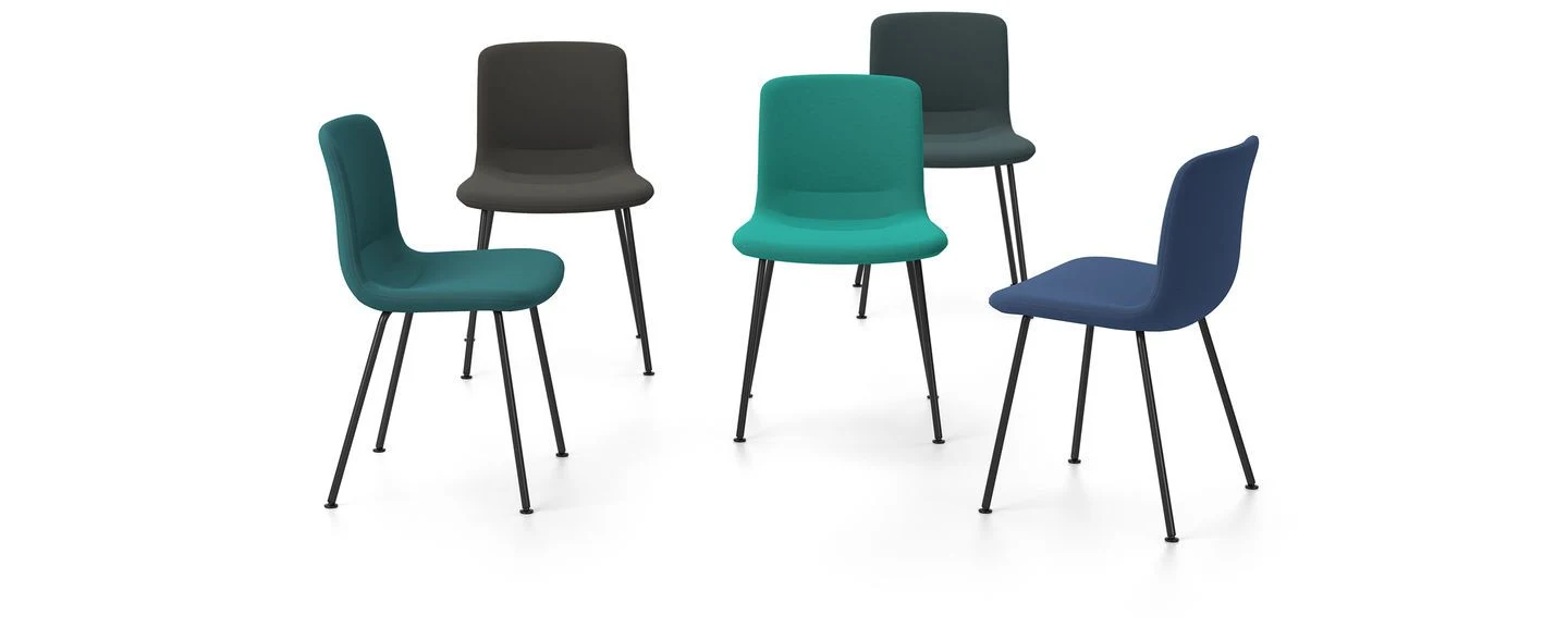 Chairs with upholstered shells on tubular bases, seen from different sides