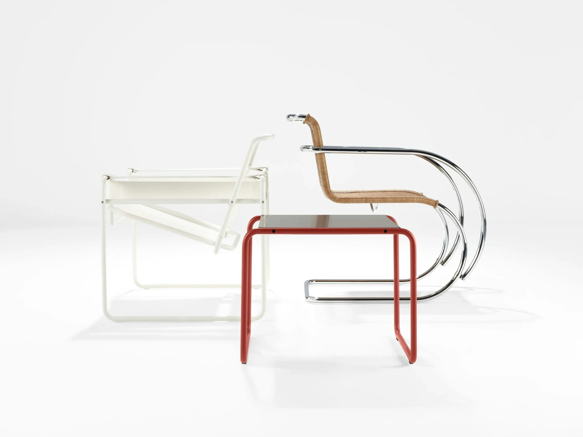 A Laccio table beside a Wassily Chair and an MR Chair