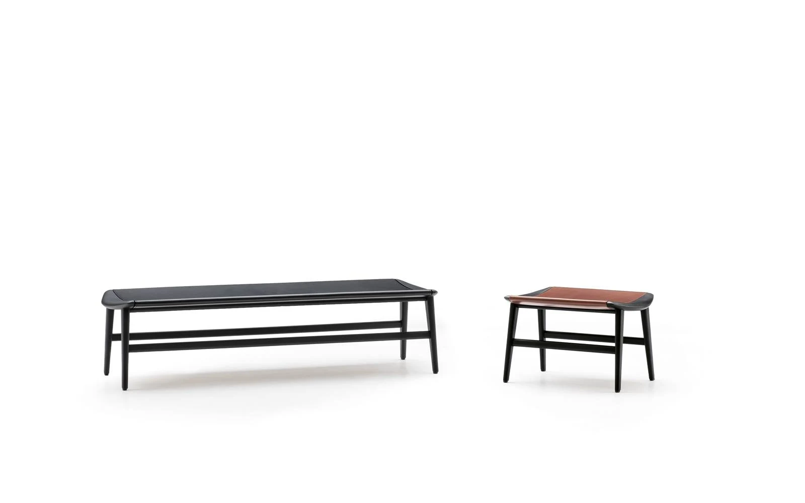 Two benches with gently curved seats on four legs, a long one and a short one