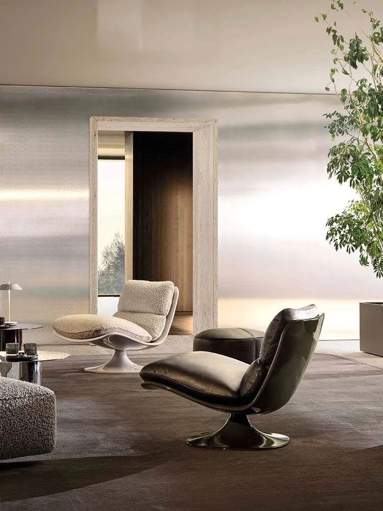 Two Pattie swivel armchairs in a room with a plant and a framed opening