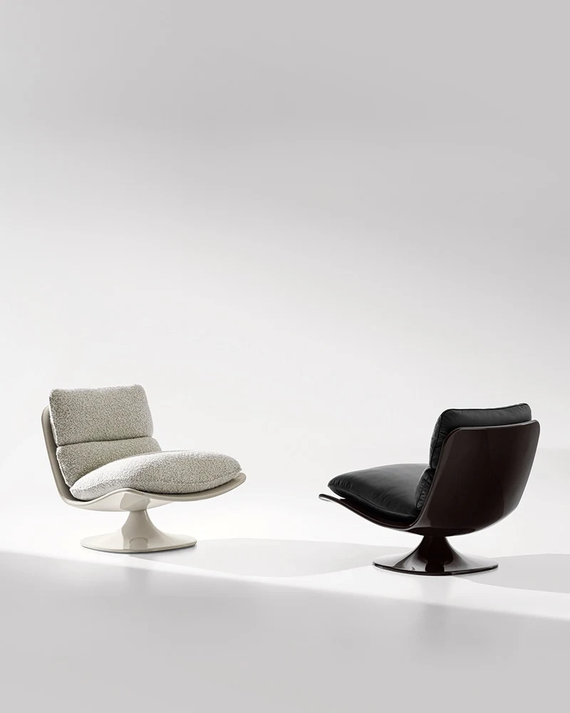 Two Pattie armchairs with different shells on a light studio backdrop