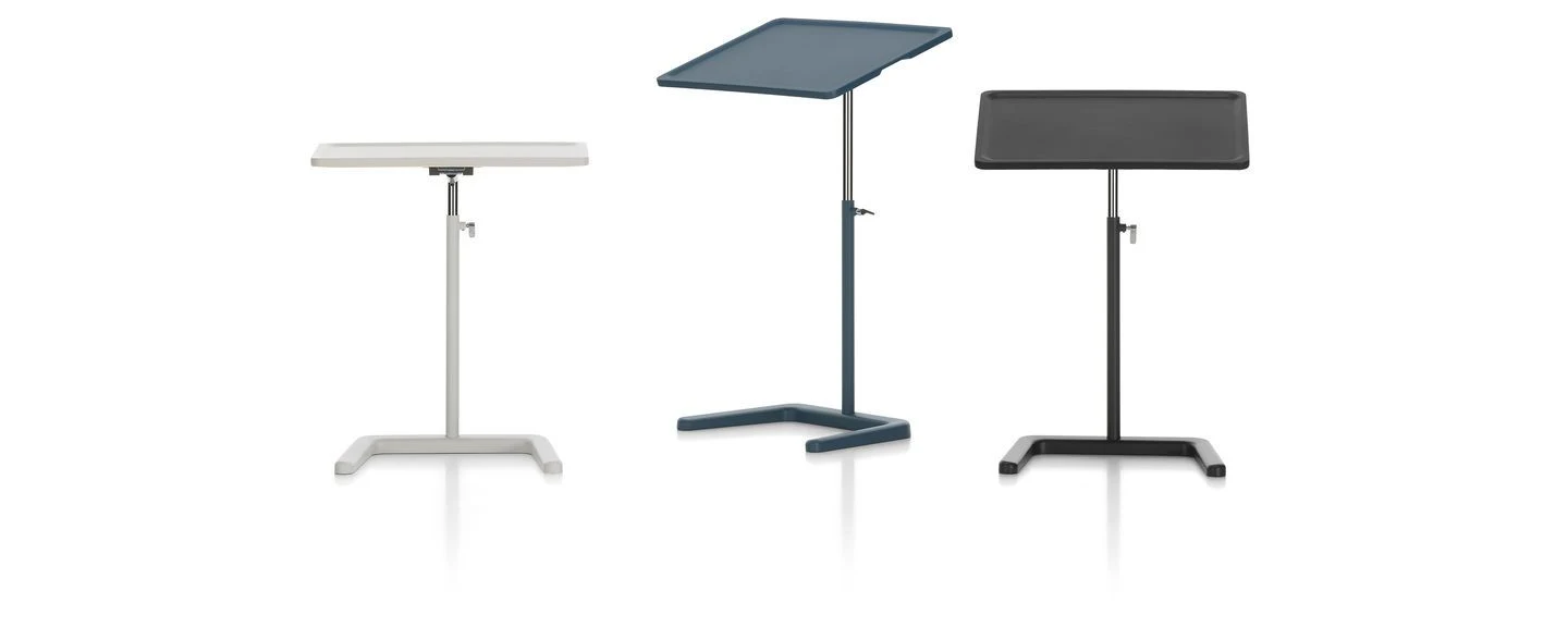 Tables with adjustable tilting trays seen from different sides on a plain background