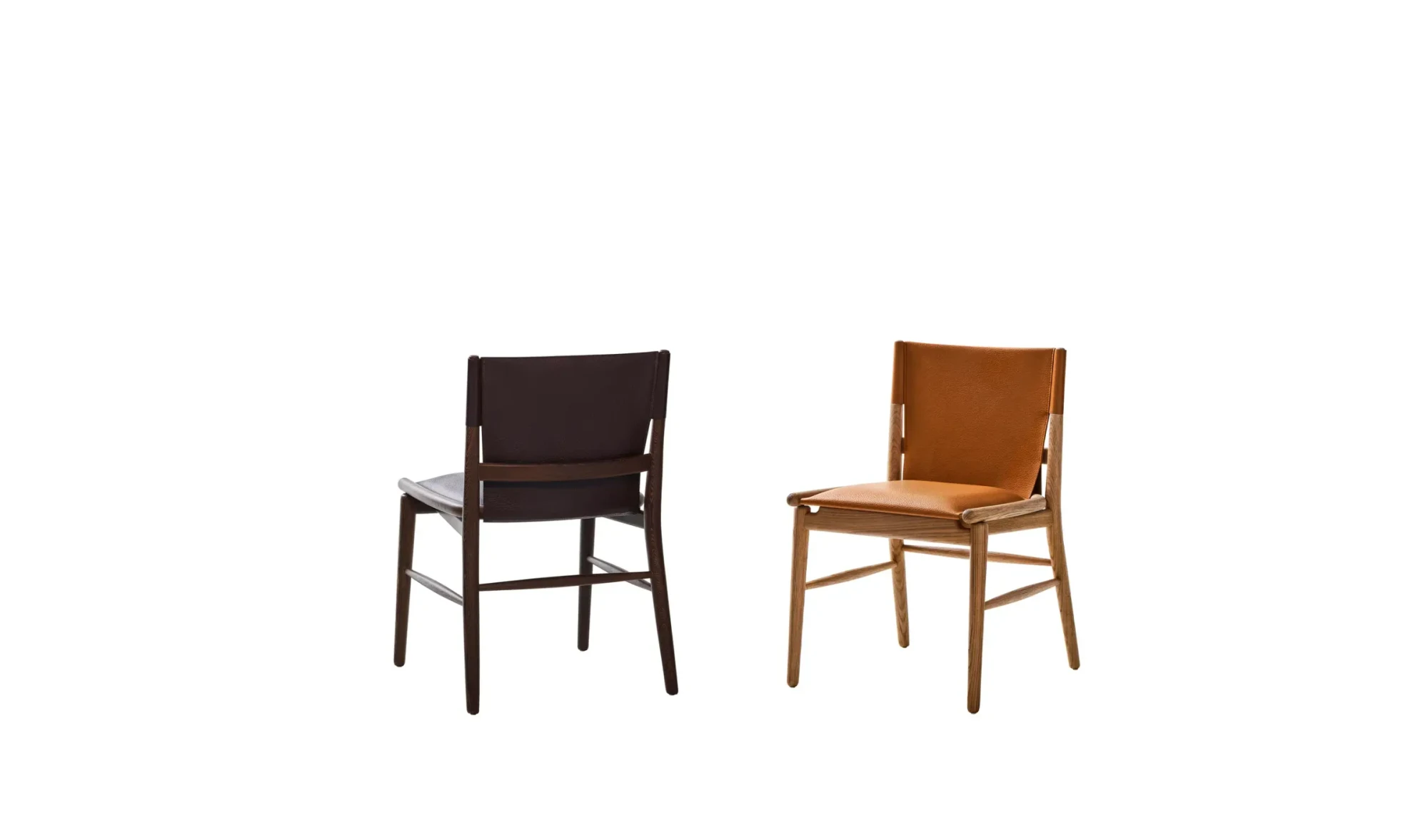 Two chairs without armrests, one seen from behind and one in front three-quarter view, each with a wood frame, on a plain background