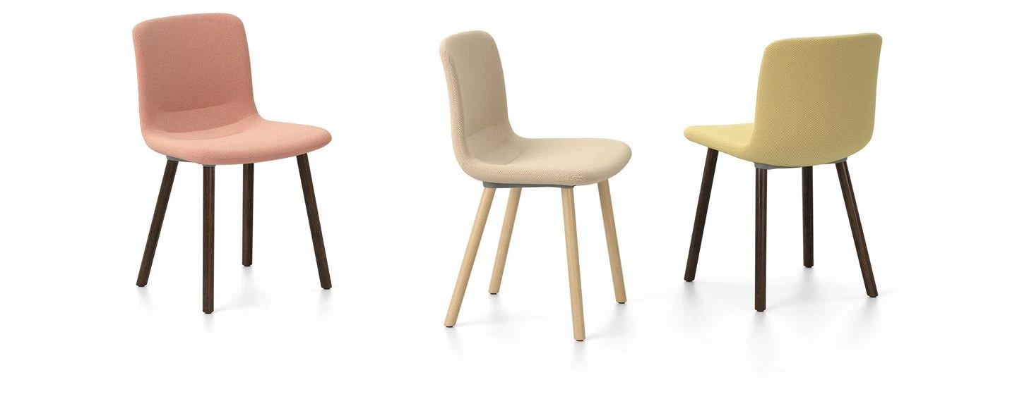 Chairs with upholstered shells on four-legged bases, seen from different sides