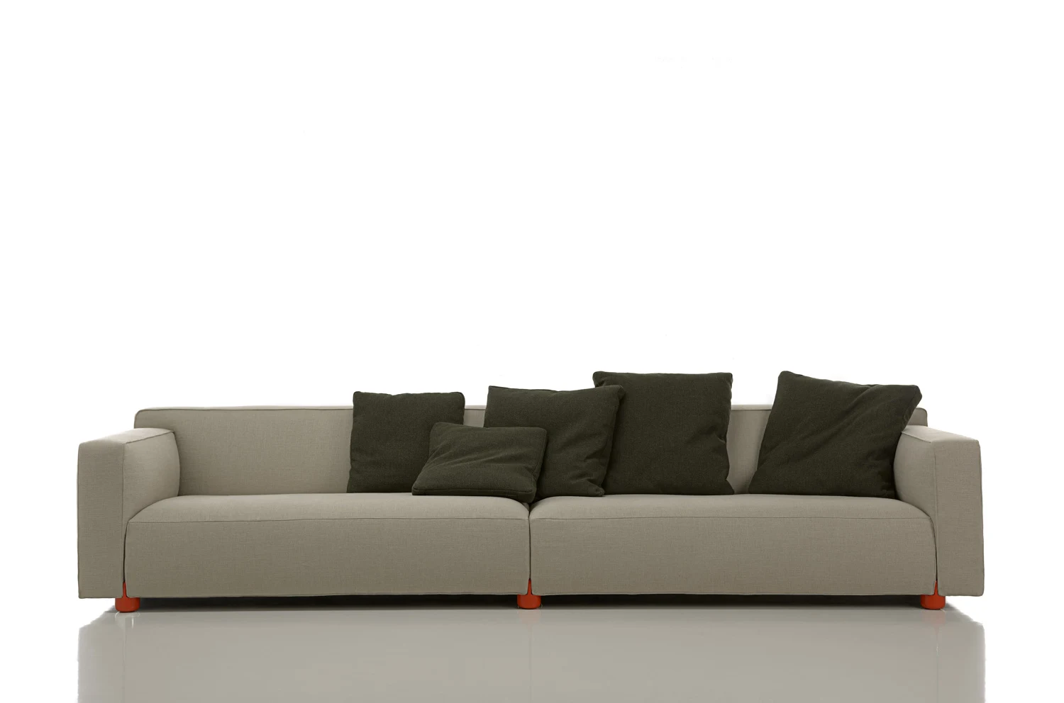 Long Barber Osgerby sofa with cushions on a plain white background